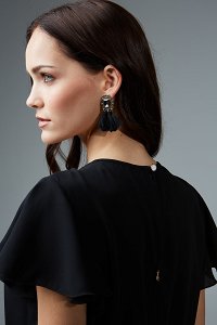 blouse featuring a ruched neckline and ruffle sleeves